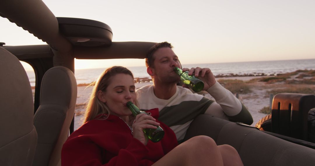 Couple Drinking Beer in Convertible at Beach Sunset - Free Images, Stock Photos and Pictures on Pikwizard.com