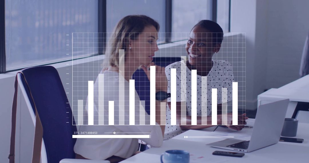 Female Colleagues Collaborating Over Bar Chart Dashboard in Bright Modern Office
