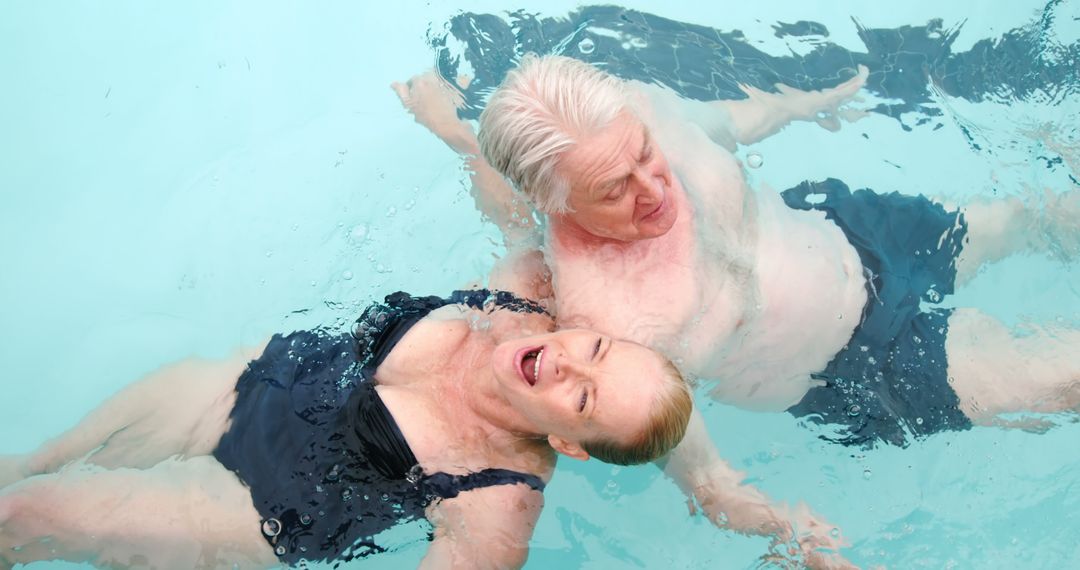 Senior Couple Swimming in Pool Enjoying Summer Day - Free Images, Stock Photos and Pictures on Pikwizard.com