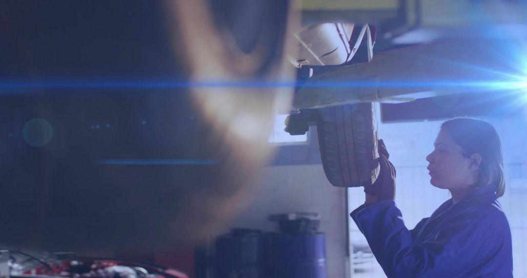 Mechanic Examining Wheel Assembly in Automotive Workshop