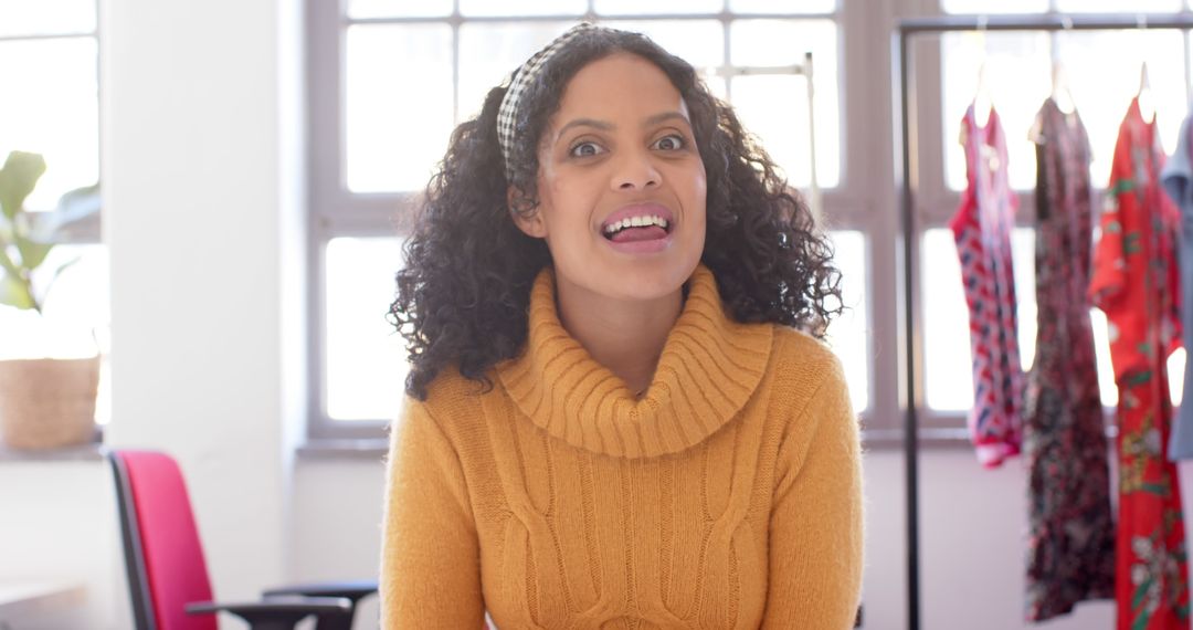 Excited Woman Smiling While Wearing a Cozy Yellow Sweater - Free Images, Stock Photos and Pictures on Pikwizard.com