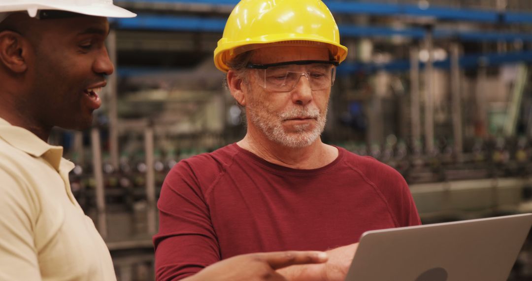 Engineers Collaborating on Laptop in Industrial Facility - Free Images, Stock Photos and Pictures on Pikwizard.com