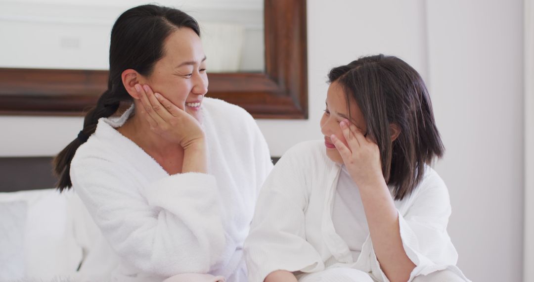 Mother and Daughter Enjoying Morning Time in Cozy Bathrobes - Free Images, Stock Photos and Pictures on Pikwizard.com