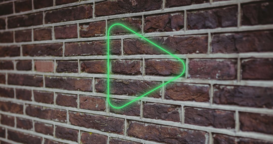 Illuminated Digital Green Play Button Icon Against Brick Wall - Free Images, Stock Photos and Pictures on Pikwizard.com