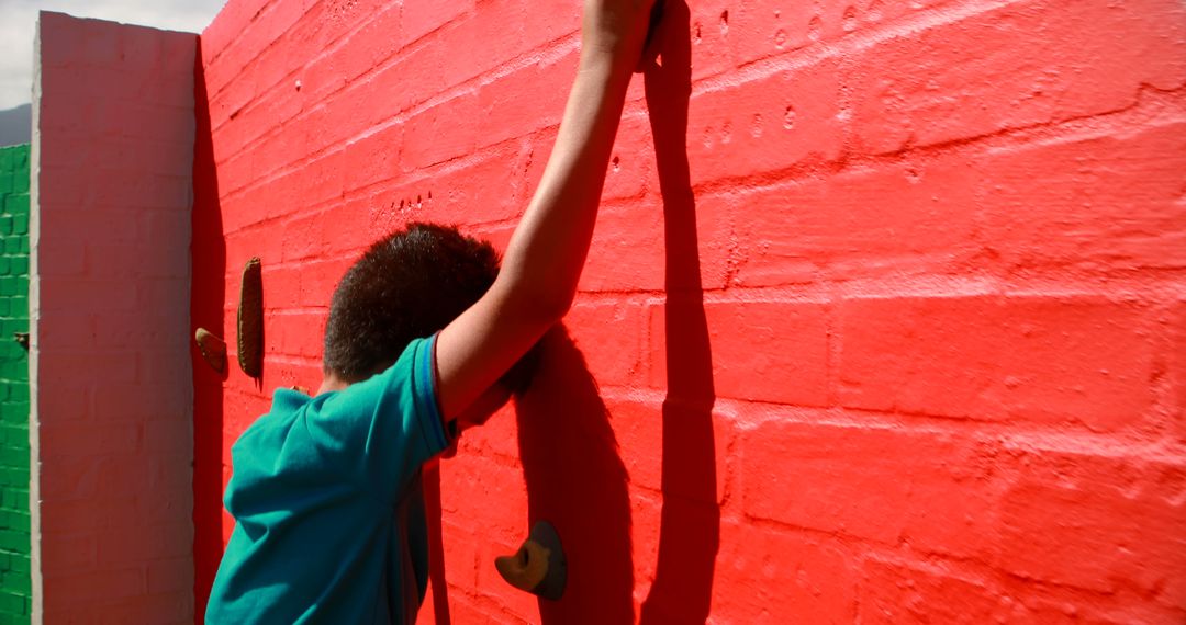 Boy Climbing Colorful Wall Outdoors - Free Images, Stock Photos and Pictures on Pikwizard.com