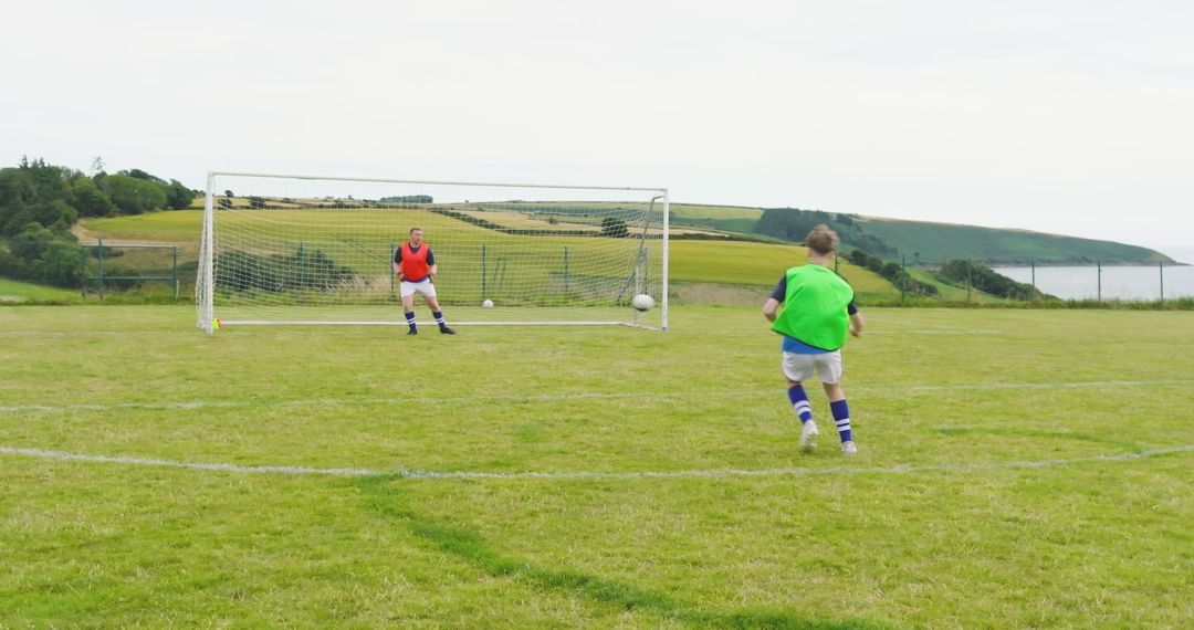 Boys Practicing Soccer on Rural Field During Penalty Training