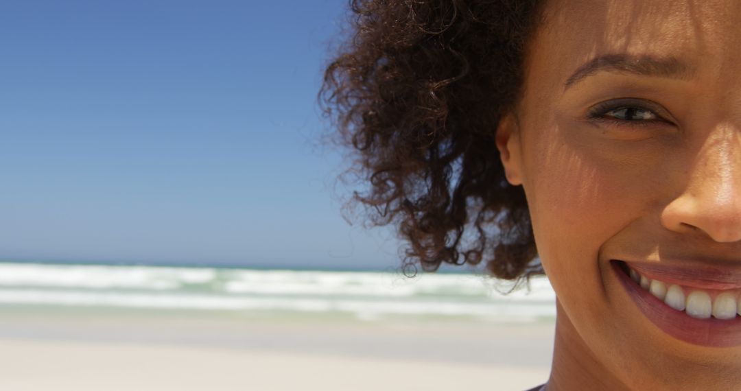 Close-up of Smiling Woman on Sunny Beach - Free Images, Stock Photos and Pictures on Pikwizard.com