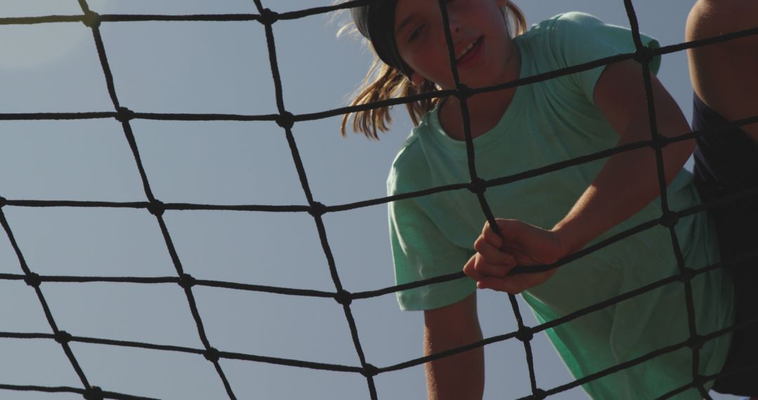 Child Climbing Rope Net on Summer Day Against Clear Sky - Free Images, Stock Photos and Pictures on Pikwizard.com