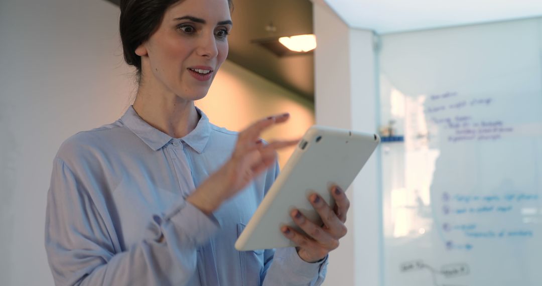 Enthusiastic Businesswoman Using Tablet in Corporate Meeting