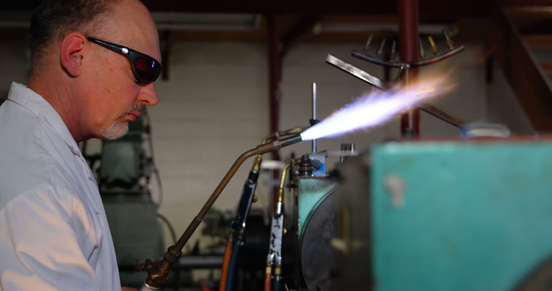 Male Industrial Worker Using Blowtorch in Workshop - Free Images, Stock Photos and Pictures on Pikwizard.com