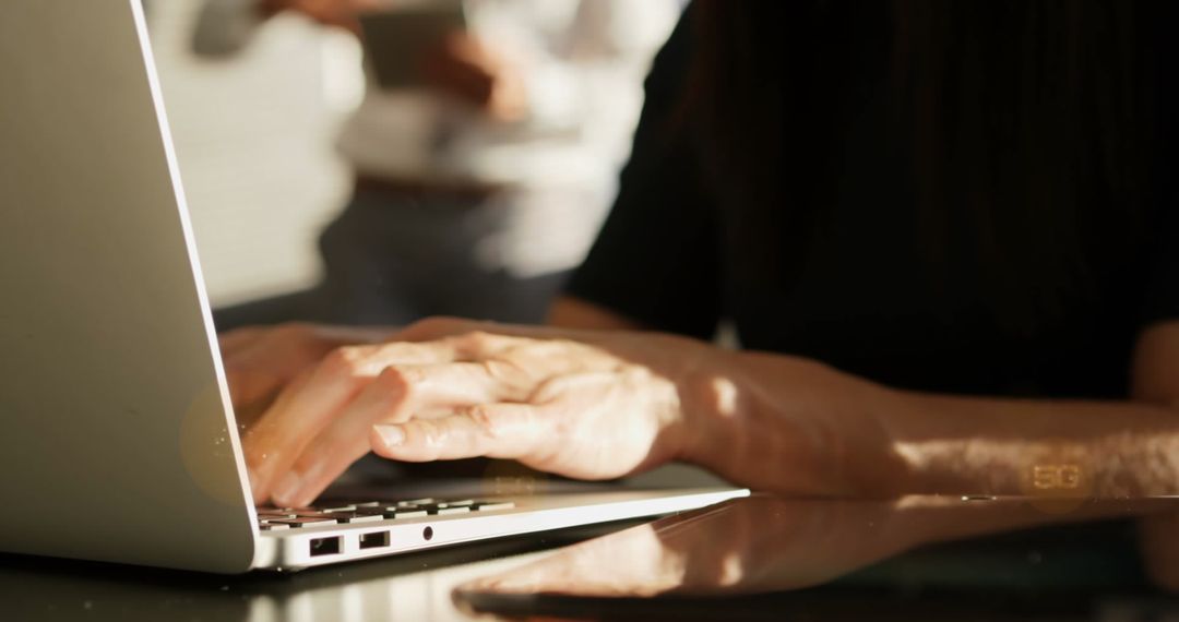 Closeup of Hands Typing on Laptop with 5G Technology Concept
