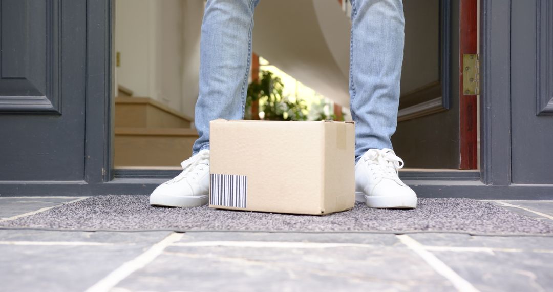 Person Collecting Package at Front Door for Online Delivery