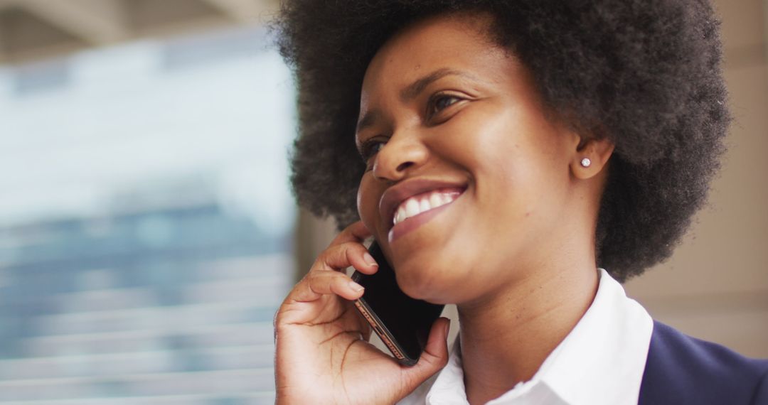 Confident Businesswoman Smiling While Using Smartphone Outdoors