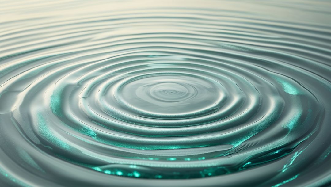 Concentric Ripples on Calm Teal Water Creating Hypnotic Wave Patterns