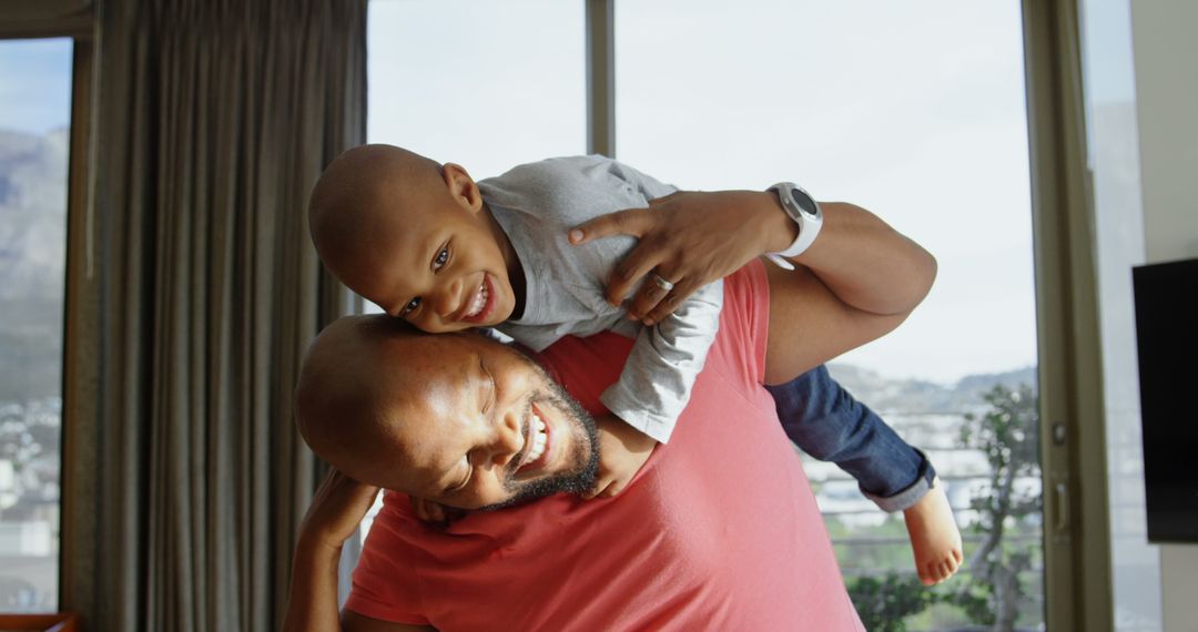 Father Piggybacking Happy Son in Home, Bonding Fun Time