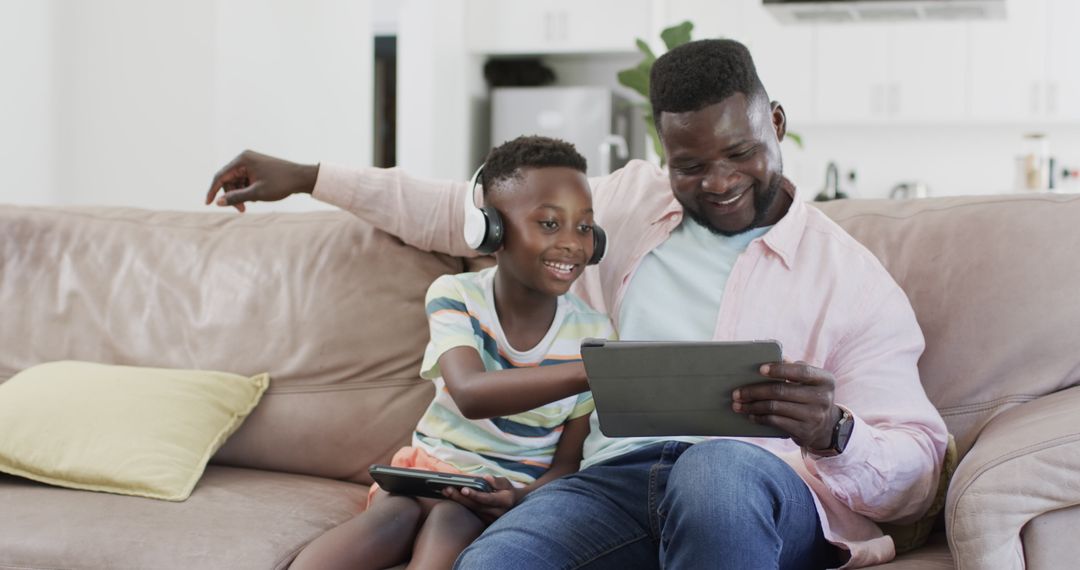 Father and Son Using Digital Tablets in Cozy Home Environment