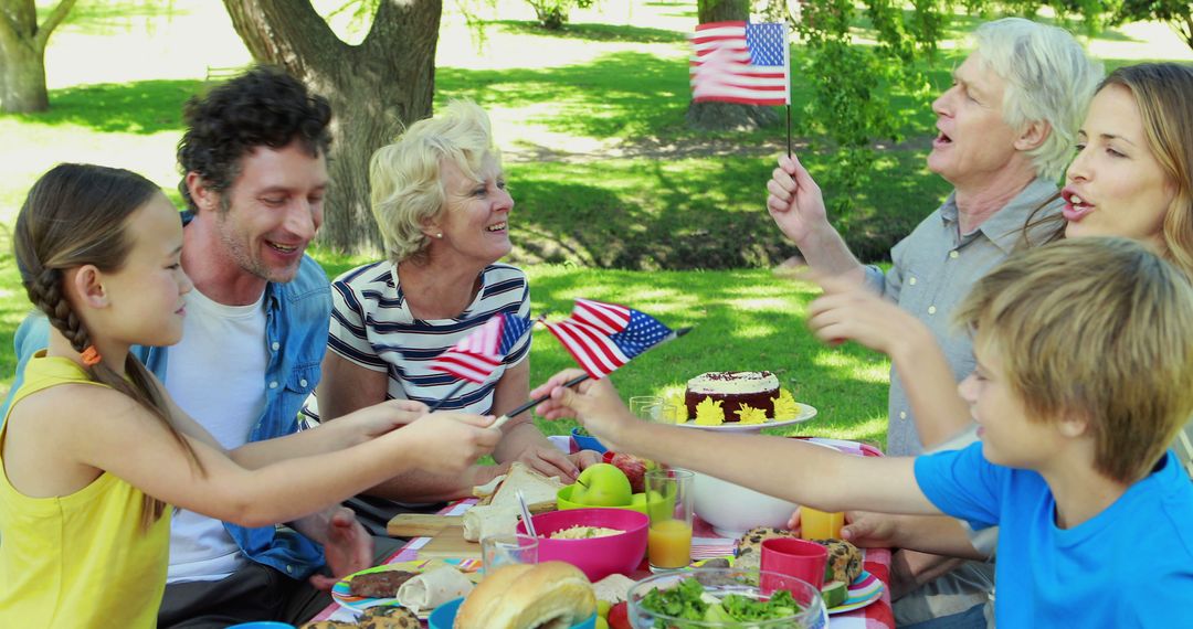 Family Picnic Celebration with American Flags in Sunny Park - Free Images, Stock Photos and Pictures on Pikwizard.com