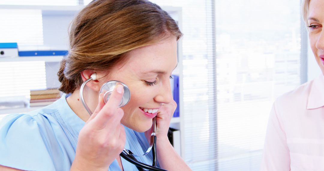 Smiling Doctor Communicating with Patient Using Stethoscope - Free Images, Stock Photos and Pictures on Pikwizard.com