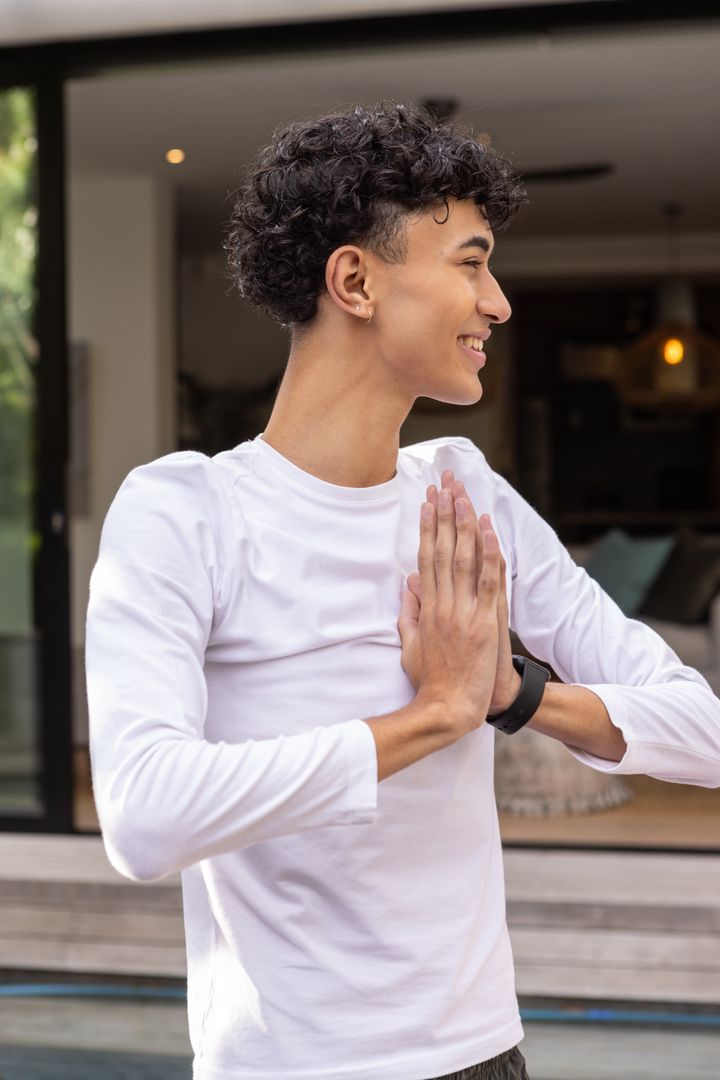 Smiling Man Practicing Yoga Exercises on Modern Patio
