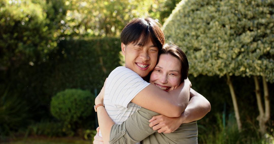 Diverse Mother and Son Embracing in Sunlit Garden