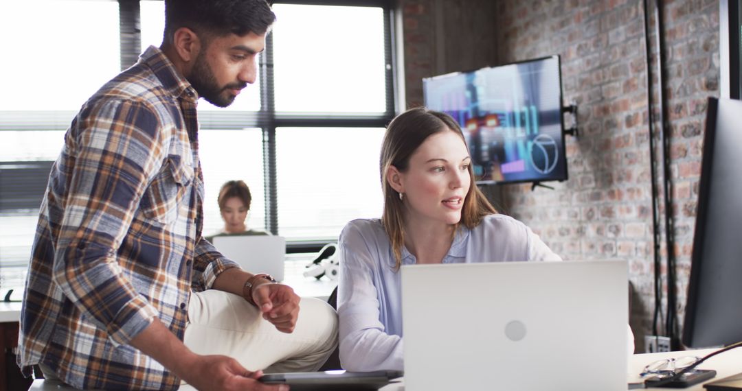 Collaborative Teamwork in Modern Office with Technology Focus