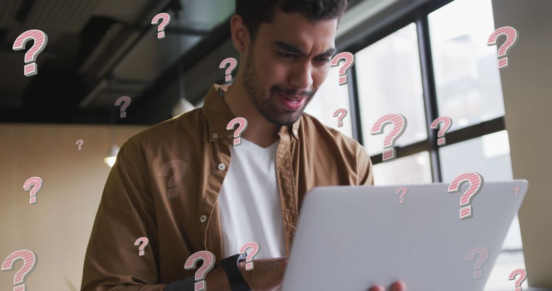 Confused Man Facing Technical Issues with Laptop in Modern Workplace