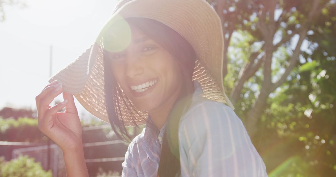 Smiling Woman Outdoors Under Sunlight with Straw Hat - Free Images, Stock Photos and Pictures on Pikwizard.com