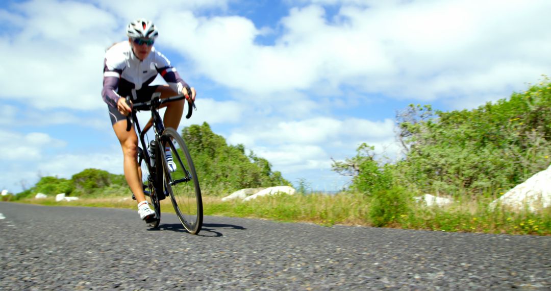 Woman Cyclist Riding Road Bike Outdoors on Sunny Day - Free Images, Stock Photos and Pictures on Pikwizard.com