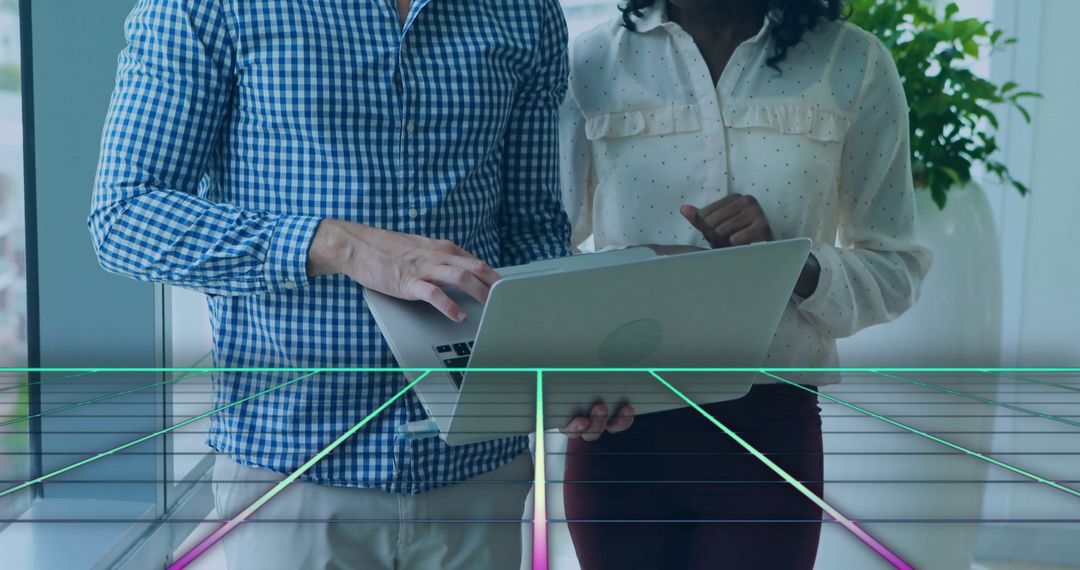 Collaborative Teamwork with Laptop and Futuristic Neon Grid