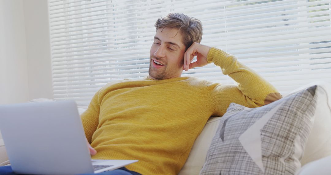 Young Man Relaxing on Couch with Laptop - Free Images, Stock Photos and Pictures on Pikwizard.com