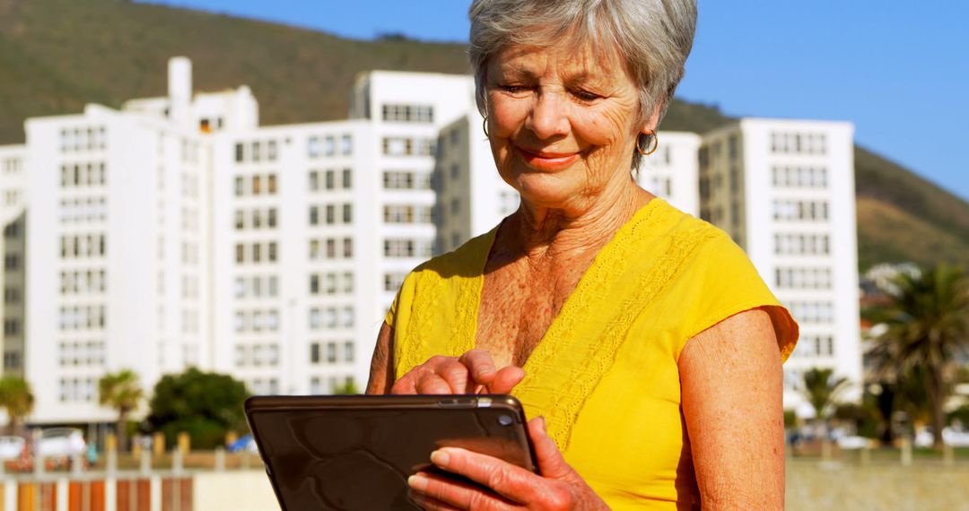 Senior Woman Enjoying Technology on Digital Tablet Outdoors - Free Images, Stock Photos and Pictures on Pikwizard.com