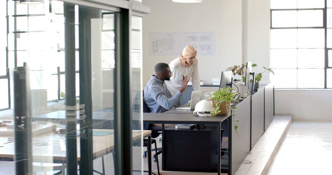 Collaborative Discussion Between Diverse Business Colleagues in Office