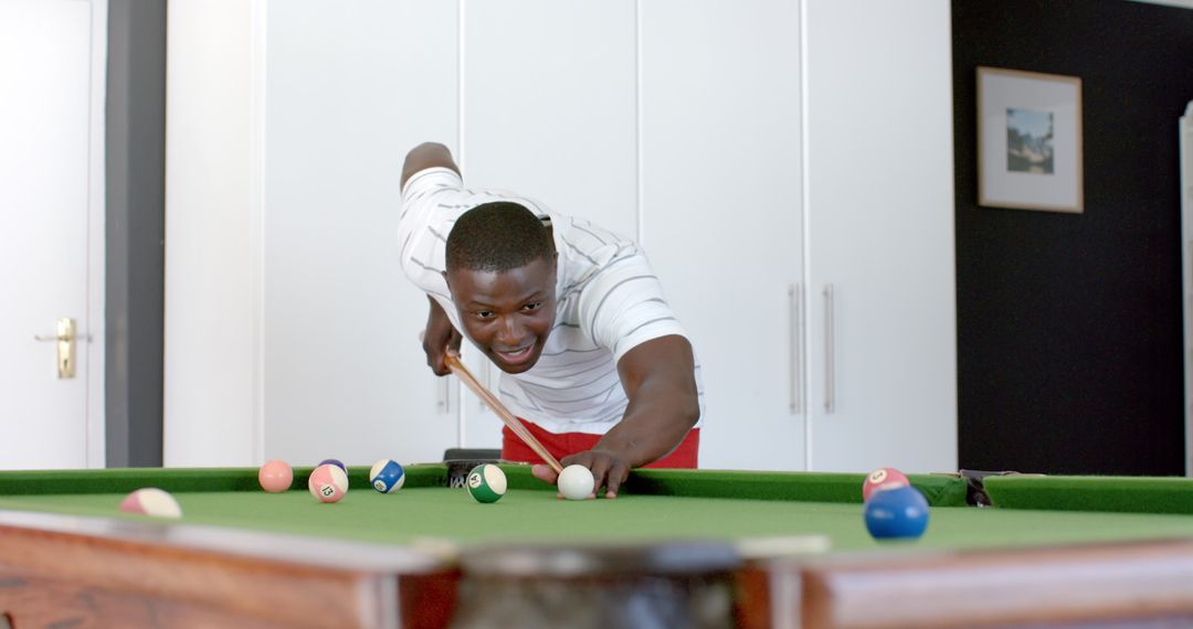 Young Man Enjoying Pool Game at Home in Leisure Time