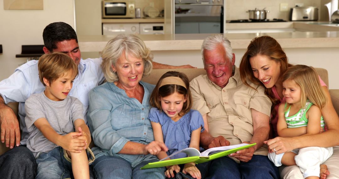 Happy multigenerational family reading on couch together at home - Free Images, Stock Photos and Pictures on Pikwizard.com