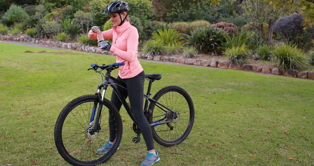 Woman Preparing Mountain Bike in Park - Free Images, Stock Photos and Pictures on Pikwizard.com