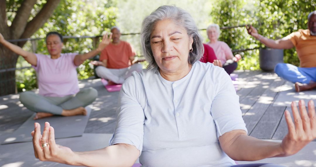 Senior Group Meditating Outdoors with Focus on Elderly Woman - Free Images, Stock Photos and Pictures on Pikwizard.com