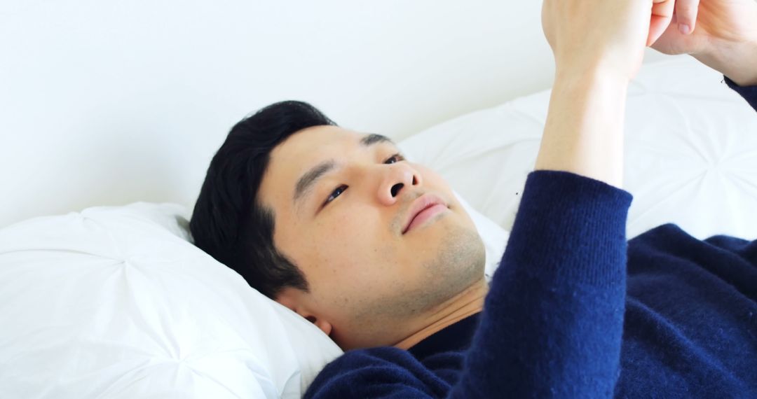 Young Man Lying in Bed Using Smartphone for Entertainment - Free Images, Stock Photos and Pictures on Pikwizard.com