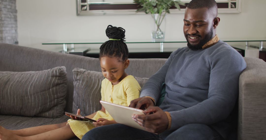 Father and Daughter Bonding, Exploring Tablets Together at Home