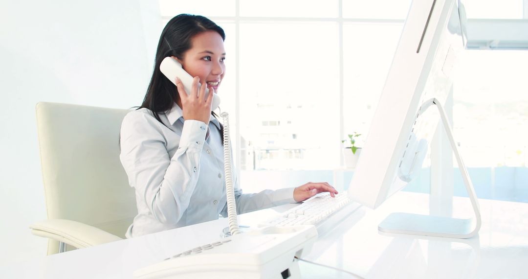 Smiling Businesswoman Talking on Phone While Working at Desk in Bright Office - Free Images, Stock Photos and Pictures on Pikwizard.com