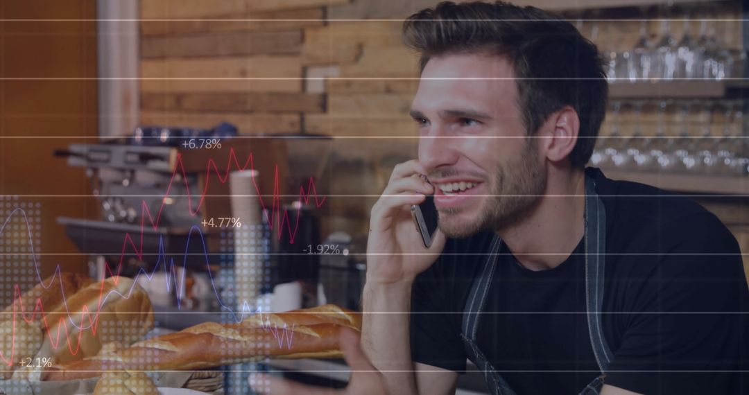 Smiling Cafe Owner Planning Strategies with Smartphone and Data Overlay