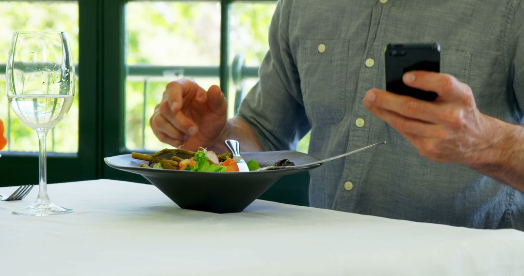 Person Eating Healthy Salad While Using Smartphone - Free Images, Stock Photos and Pictures on Pikwizard.com