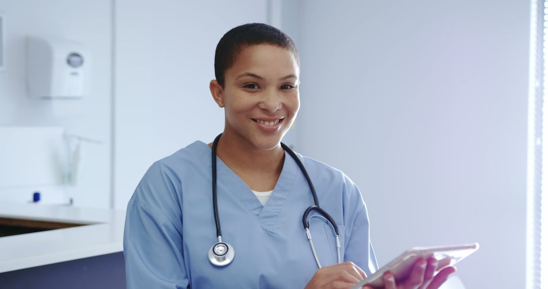 Smiling Nurse Holding Tablet in Modern Clinic - Free Images, Stock Photos and Pictures on Pikwizard.com