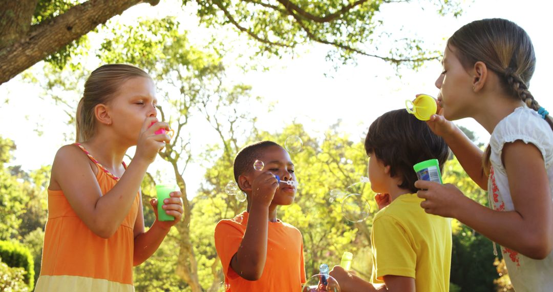 Children Enjoying Bubble Blowing Outdoors on Summer Day - Free Images, Stock Photos and Pictures on Pikwizard.com