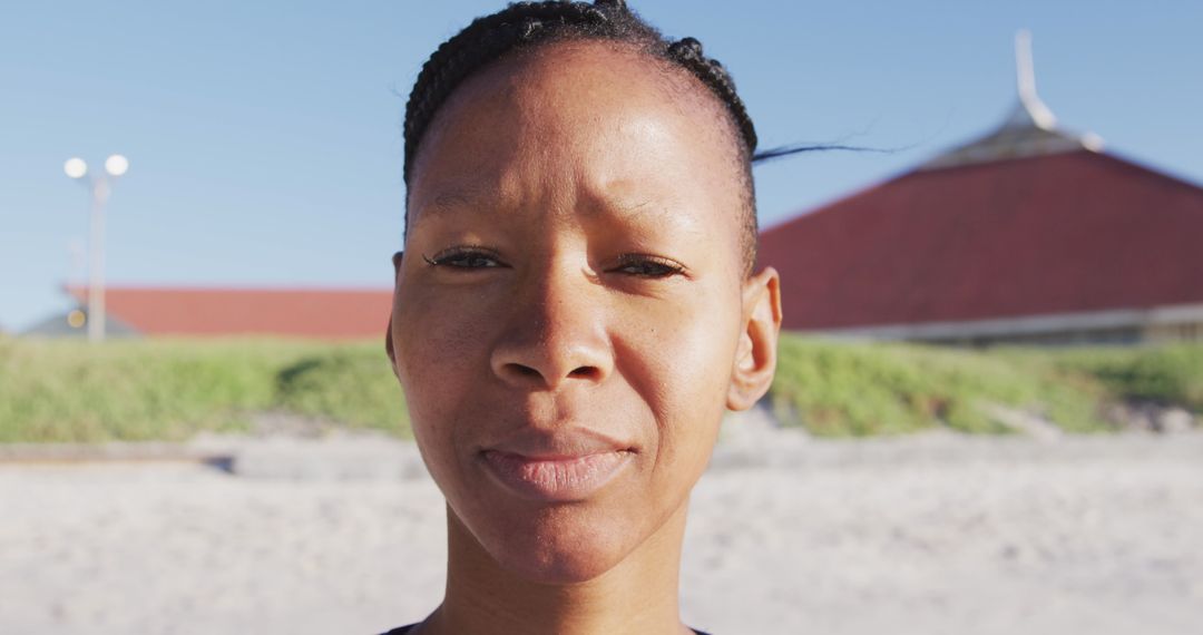 Woman Practicing Yoga on Beach with Calm Expression