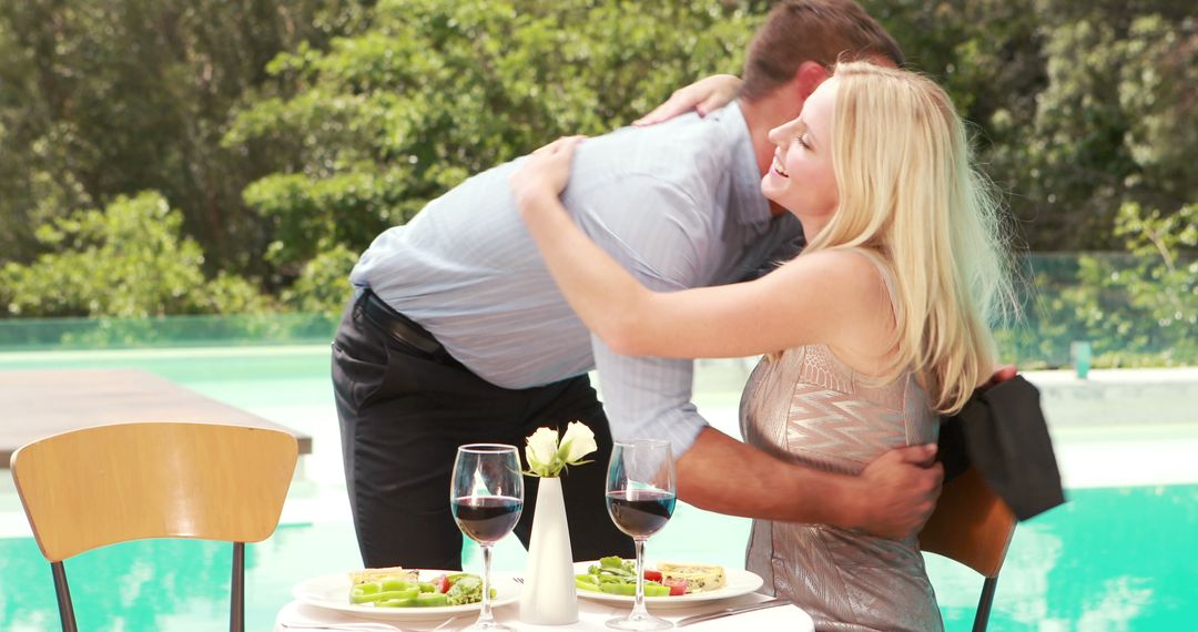A Caucasian couple enjoys a romantic embrace by a poolside dining table, with copy space - Free Images, Stock Photos and Pictures on Pikwizard.com