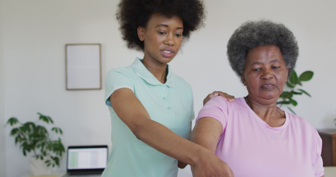 Young Therapist Assists Senior Woman with Physical Therapy Exercise - Free Images, Stock Photos and Pictures on Pikwizard.com