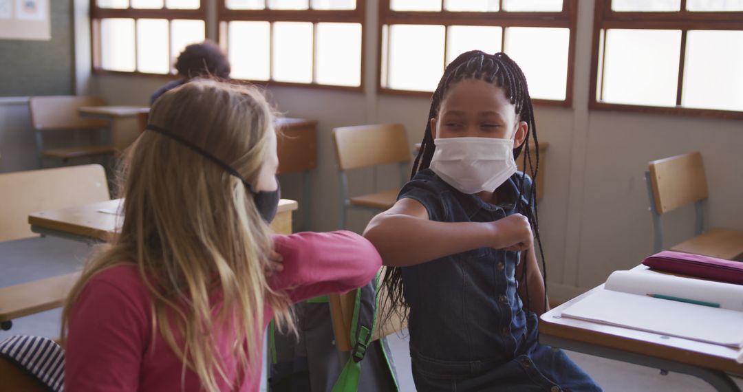 Diverse Schoolchildren Wearing Masks in Classroom Elbow Bumping - Free Images, Stock Photos and Pictures on Pikwizard.com