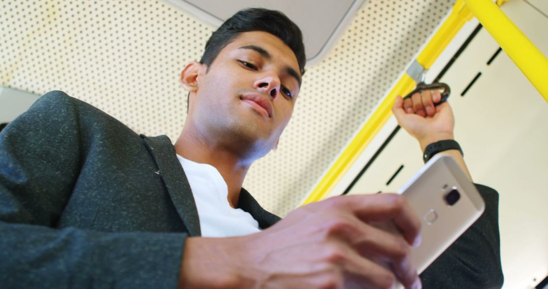 Young Man Commuting Using Smartphone on Public Transport - Free Images, Stock Photos and Pictures on Pikwizard.com