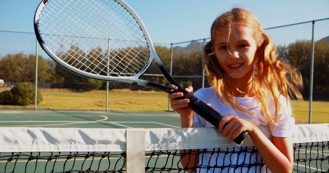 Young Girl Holding Tennis Racket at Outdoor Tennis Court - Free Images, Stock Photos and Pictures on Pikwizard.com