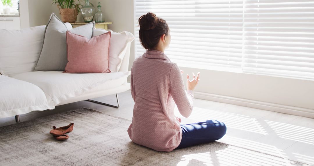 Woman Meditating in Modern Living Room with Sunlight - Free Images, Stock Photos and Pictures on Pikwizard.com